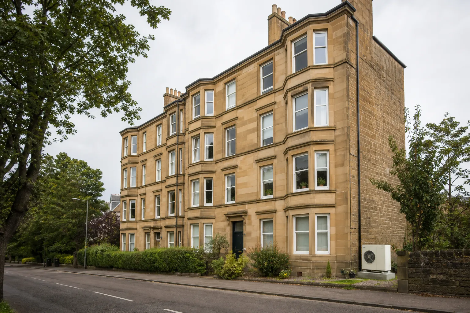 Edinburgh street of stone tenement flats with an air source heat pump